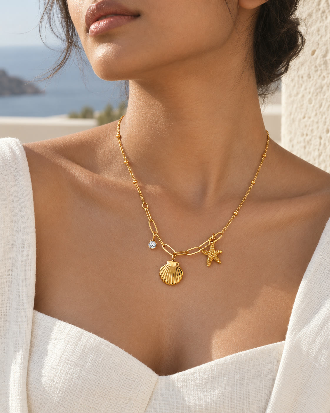 A coastal charm necklace worn with relaxed daytime styling