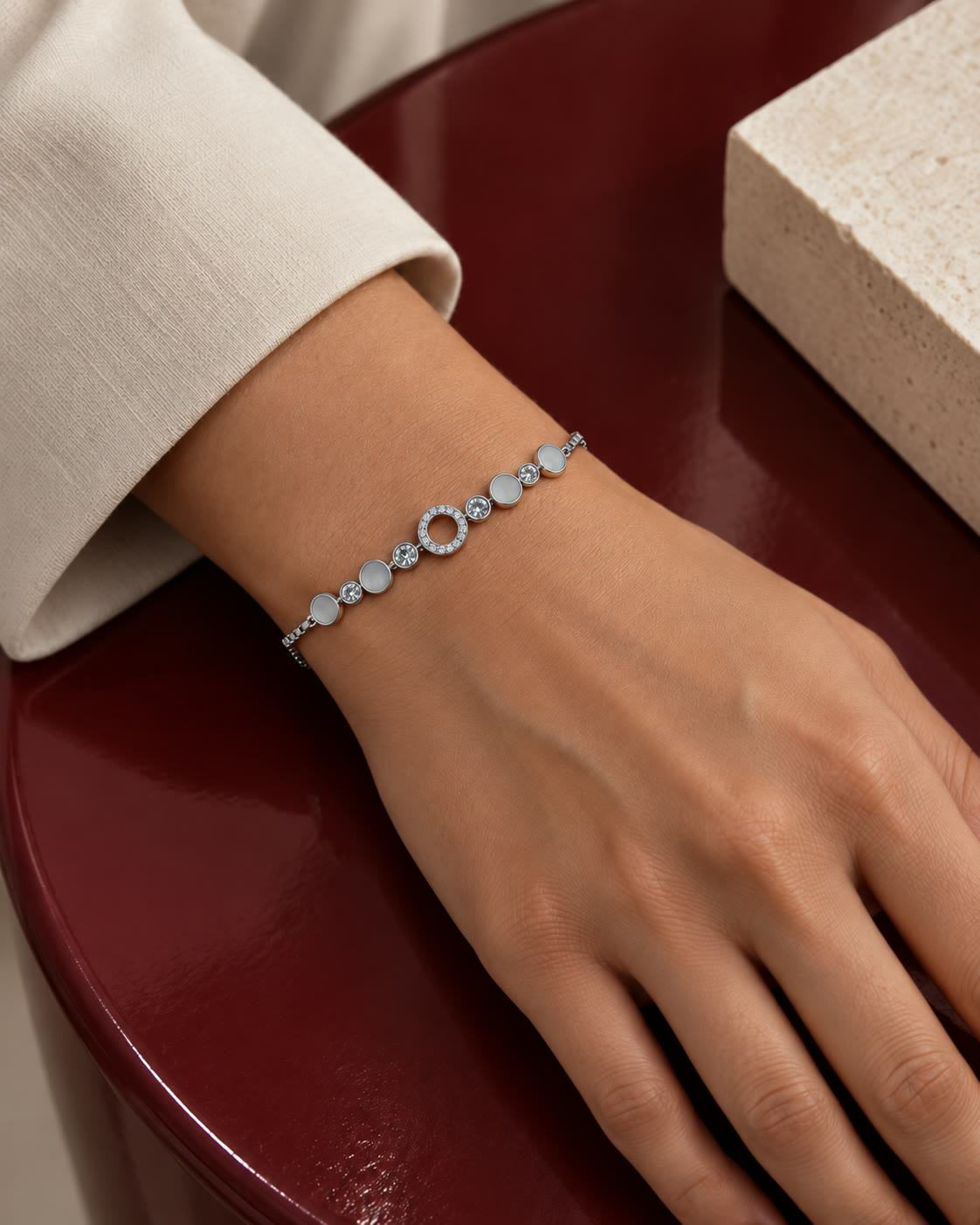 A circular station bracelet resting at the wrist