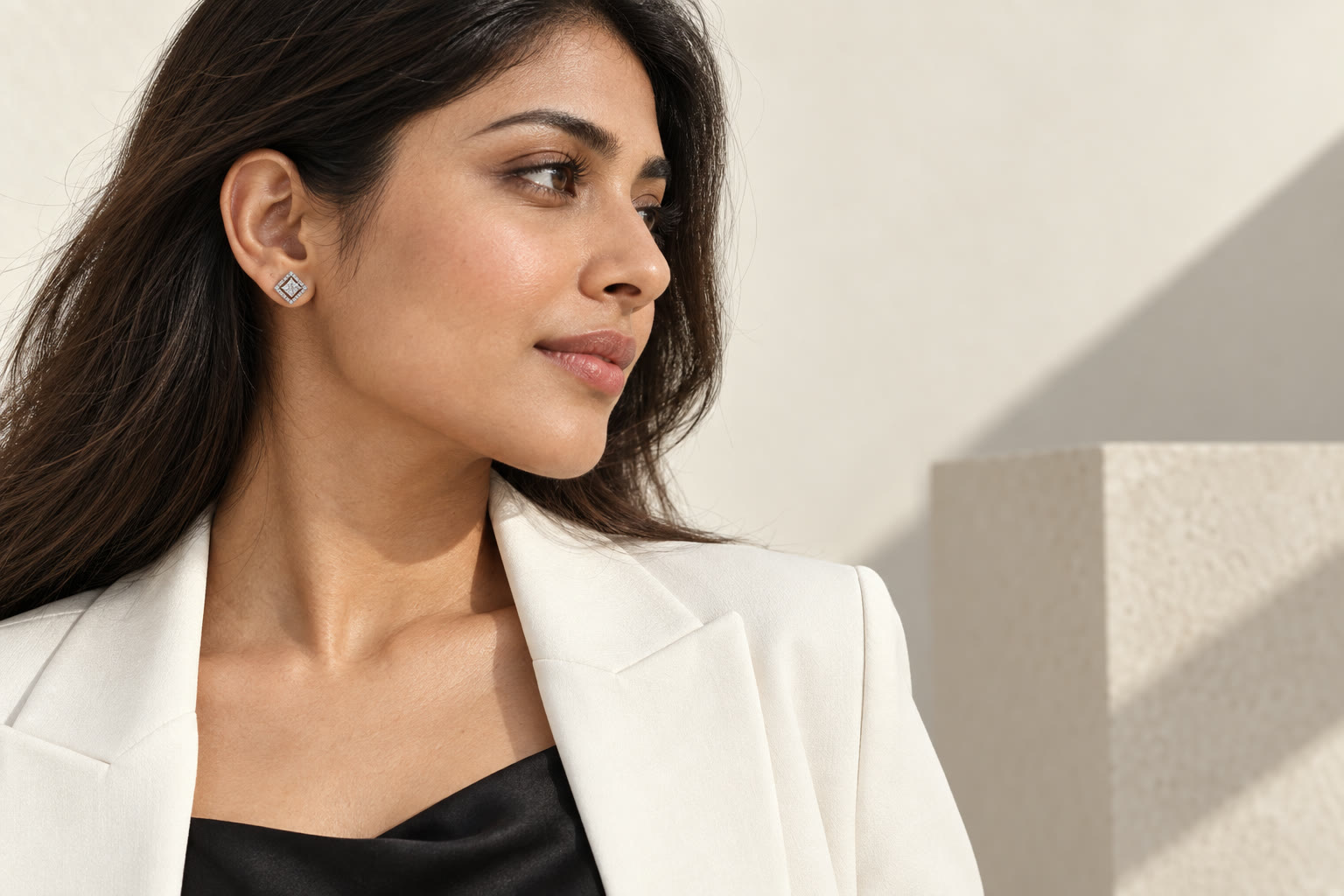 Square halo crystal stud earrings worn with hair swept back